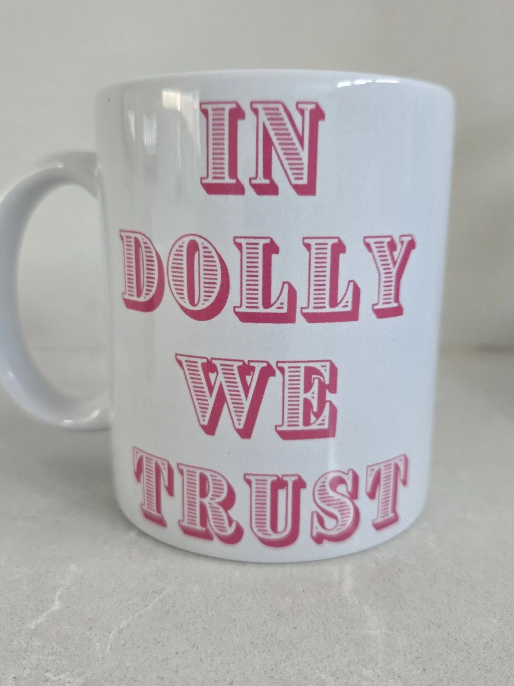 In Dolly We Trust Brand New Ceramic Coffee Mug Dolly Pardon White Pink 3.75